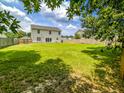 Expansive backyard featuring a well-maintained lawn and a sturdy wooden fence for privacy at 1350 Pinyon Pine Dr, Ladson, SC 29456