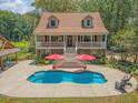 Charming two-story home has a pool, full front porch, and an outdoor kitchen at 150 Riverbend Ln, Ridgeville, SC 29472