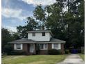 Charming two-story brick home with a well-maintained lawn and driveway leading to the street at 1674 Garden St, Charleston, SC 29407