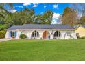 A beautifully maintained home with a lush lawn and a unique, arched window design adding curb appeal at 204 Foxborough Rd, Goose Creek, SC 29445