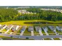 Beautiful aerial view of homes in a community with a lake and lush green trees at 225 N Light Way, Summerville, SC 29486