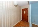 Front entry showcases a hardwood floor, patterned wallpaper, and a solid wood door at 2320 Wofford Rd, Charleston, SC 29414