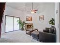 A cozy living room featuring a fireplace, comfortable seating, and stylish decor with modern ceiling fan and paint at 2334 Treescape Dr # 2006, Charleston, SC 29414
