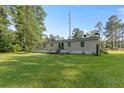 Expansive backyard with lush green grass and mature trees at 250 W Medina St, Summerville, SC 29483