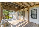 Inviting covered front porch with wooden decking and a cozy seating area at 250 W Medina St, Summerville, SC 29483