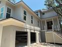 Inviting two-story home with large windows, covered entry, and open garage at 2706 Old Oak Walk, Seabrook Island, SC 29455