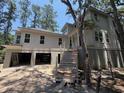 Two-story home with steps leading up to covered entry and open garage space at 2706 Old Oak Walk, Seabrook Island, SC 29455
