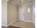 Foyer with tile flooring, crown molding, and neutral paint at 271 Village Stone Cir, Summerville, SC 29486