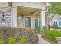 Inviting front porch with stone accents and a glass front door at 271 Village Stone Cir, Summerville, SC 29486