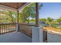 View from front porch shows wood railing and pillars with a brick base to the ground at 2924 Chicora Ave, North Charleston, SC 29405