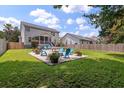 Enjoy outdoor living on this patio with ample seating in a fenced backyard at 3038 Penny Ln, Johns Island, SC 29455