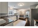 Bright kitchen features stainless steel appliances, white cabinetry, and dark hardwood floors at 3038 Penny Ln, Johns Island, SC 29455