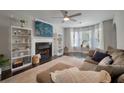 Inviting living room featuring a cozy fireplace, large windows, and hardwood flooring at 3038 Penny Ln, Johns Island, SC 29455
