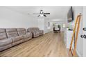 Bright living room with hardwood floors, ceiling fan, and a view to the dining area at 307 Wilderland Ct, Moncks Corner, SC 29461