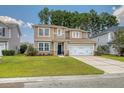 Traditional two-story home featuring mixed siding, a well-manicured lawn, and a two-car garage at 314 Sanctuary Park Dr, Summerville, SC 29486