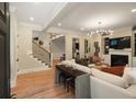 Bright living room with hardwood floors, fireplace, and staircase to the second floor at 316 Bridgetown Pass, Mount Pleasant, SC 29464