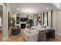 Spacious living room with fireplace, built-in shelves, modern lighting, and hardwood floors at 316 Bridgetown Pass, Mount Pleasant, SC 29464