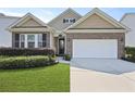 Charming brick home with a well-manicured lawn, a two car garage, and manicured shrubbery at 316 Knawl Rd, Moncks Corner, SC 29461