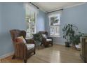 Inviting room featuring light blue walls, hardwood floors, plants and wicker chairs at 3525 E Higgins Dr, Mount Pleasant, SC 29466