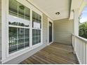 Inviting outdoor balcony with wood decking, white railing and natural light is perfect for relaxing and enjoying nature at 3705 Sandy Gate Ln, Mount Pleasant, SC 29466