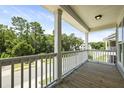 Relaxing balcony showcasing natural views, wood decking and white railing is perfect for enjoying the outdoors at 3705 Sandy Gate Ln, Mount Pleasant, SC 29466