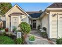 Welcoming front porch with a decorative wreath, bench, and potted plants at 419 Equinox Cir, Ladson, SC 29456