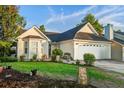 Inviting single story home with manicured landscaping and a cozy bench on the front porch at 419 Equinox Cir, Ladson, SC 29456