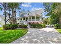 Beautiful two-story home with a lovely front porch and a circular driveway at 5394 Clairmont Ln, North Charleston, SC 29420