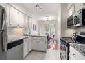 Well-lit kitchen featuring white cabinets, granite countertops, and stainless steel appliances at 5558 Green Dolphin Way, Kiawah Island, SC 29455