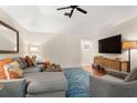 Comfortable living room features a sectional sofa, wood floors, and a modern entertainment center at 5558 Green Dolphin Way, Kiawah Island, SC 29455
