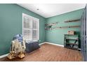 Unique bedroom with hardwood floors, shuttered windows, a fun aesthetic, and great natural light at 578 Delafield Dr, Summerville, SC 29483