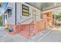 Angle view showcasing brick steps, covered area, and side yard of a charming single-story home at 6 Dewey St, Charleston, SC 29403