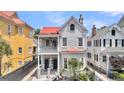 Classic home featuring a red roof, dual balconies, and symmetrical facade at 68 Vanderhorst St # A, Charleston, SC 29403