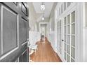 Elegant hallway with hardwood floors, white wainscoting, and decorative lighting at 68 Vanderhorst St # A, Charleston, SC 29403