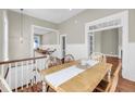Elegant dining room with wood table, chair, and flooring adjacent to the kitchen and living area at 68 Vanderhorst St # B, Charleston, SC 29403