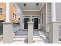 Inviting entryway with dual front doors, decorative columns, and well-maintained steps create a welcoming first impression at 68 Vanderhorst St # B, Charleston, SC 29403
