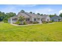 Charming single-story home with large manicured front yard, stone accents, and inviting front porch at 708 Tierra Loop, Summerville, SC 29483