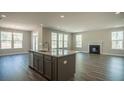 Inviting living room with a fireplace and large windows offering an abundance of natural light at 713 Breakers Reef Ln, Huger, SC 29450