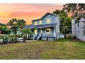 Charming two-story home featuring a covered front porch and well-manicured lawn at 721 Lake Frances Dr, Charleston, SC 29412