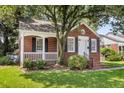 Charming brick home with manicured lawn, covered porch, and classic architectural details at 727 Savannah Hwy, Charleston, SC 29407