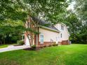 A view of the rear corner of this home with a large backyard and lush plantings at 8316 Dye Makers, North Charleston, SC 29418