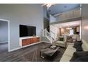 Spacious living room with open floor plan, modern decor, lots of natural light, and staircase to the upper level at 8721 Grassy Oak Trl, North Charleston, SC 29420