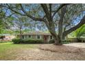 Charming brick home with a mature tree, manicured lawn and inviting curb appeal at 943 Mikell Dr, Charleston, SC 29412