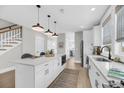 Bright kitchen featuring a large island with pendant lighting and modern appliances at 101 Hanover St, Charleston, SC 29403