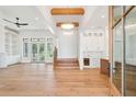 Spacious living room with hardwood floors and ceiling fan, leads into a bright kitchen at 105 Peninsula Dr, Ravenel, SC 29470