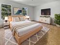 Cozy main bedroom with a king bed, soft rug, dresser, TV, and natural light from windows at 120 Apache Dr, Summerville, SC 29483