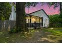 Twilight view of a charming home with a cozy porch and inviting tree swing at 1248 Sumner Ave, North Charleston, SC 29406