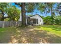 Charming home with a cozy front porch and mature trees on a sunny day at 1248 Sumner Ave, North Charleston, SC 29406