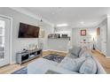 Open living room with wood floors and a view of the dining area and kitchen at 1300 Park West Blvd # 512, Mount Pleasant, SC 29466
