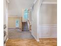 Spacious foyer with hardwood floors, carpeted stairs, and an arched entryway to the living spaces at 1308 Wild Olive Dr, Mount Pleasant, SC 29464
